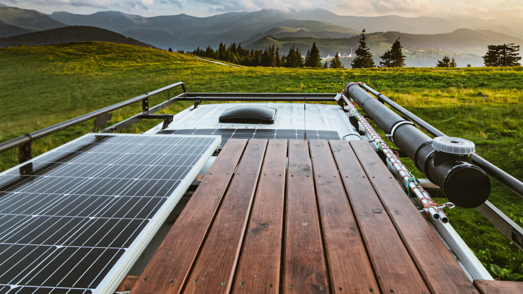 solar panel at top of hill overlooking green valley