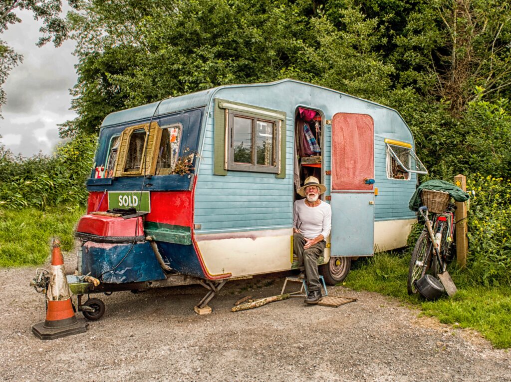 A man staying in a cheapt camper.