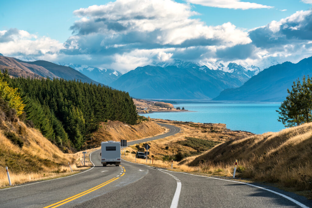 Road trip of Mt Cook over winding road with motorhome driving on sunny day at Peters lookout New Zealand